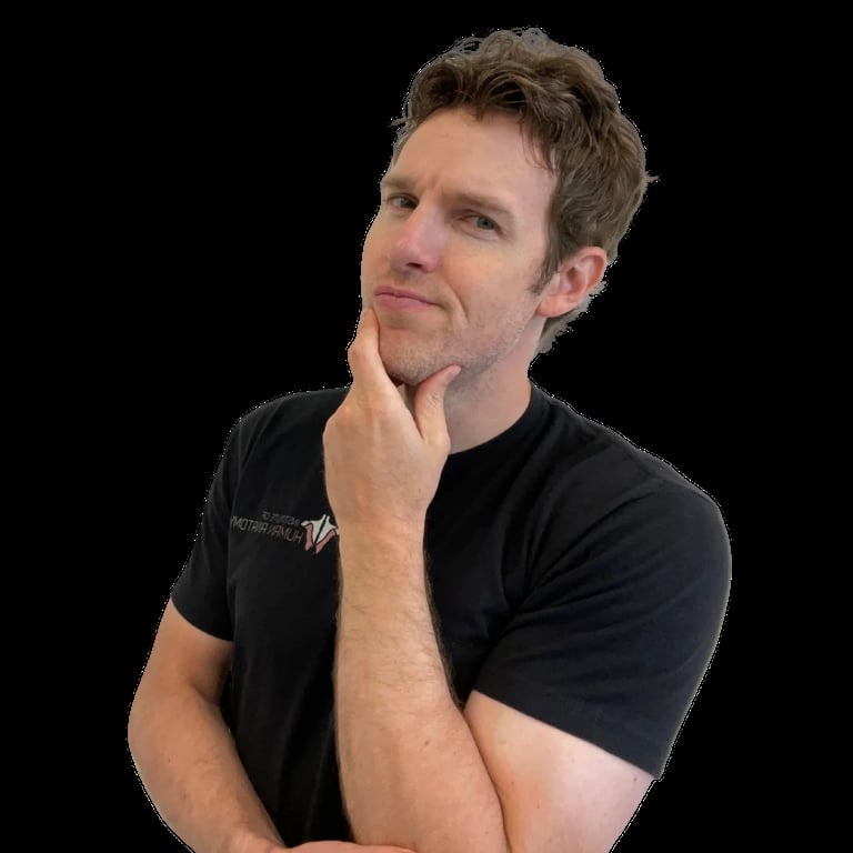 Man in black t-shirt with hand to chin in thoughtful pose against black background